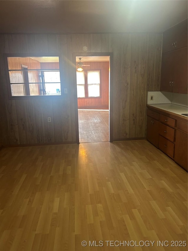 spare room featuring wood walls and light wood-style flooring