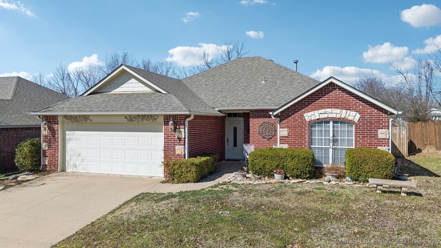 ranch-style home with concrete driveway, an attached garage, brick siding, and a shingled roof