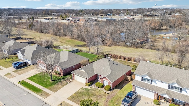 drone / aerial view featuring a water view and a residential view