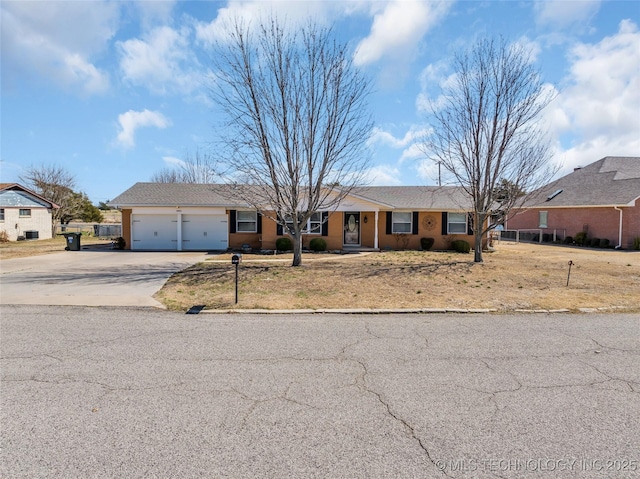 ranch-style home featuring a garage and driveway