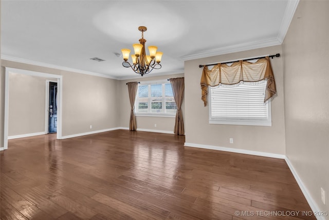 spare room featuring ornamental molding, wood finished floors, visible vents, and an inviting chandelier