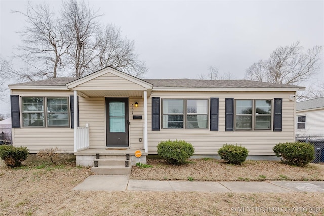 bungalow-style home with a shingled roof