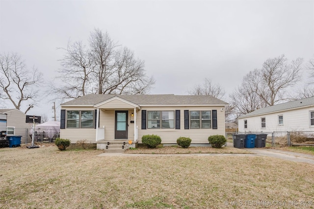 view of front of house with entry steps, a gate, fence, and a front yard