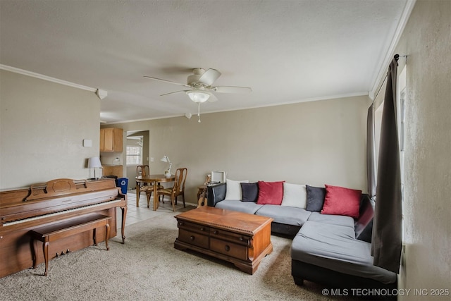 living area with ceiling fan, crown molding, and light colored carpet