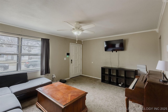 carpeted living area featuring ornamental molding, ceiling fan, and baseboards