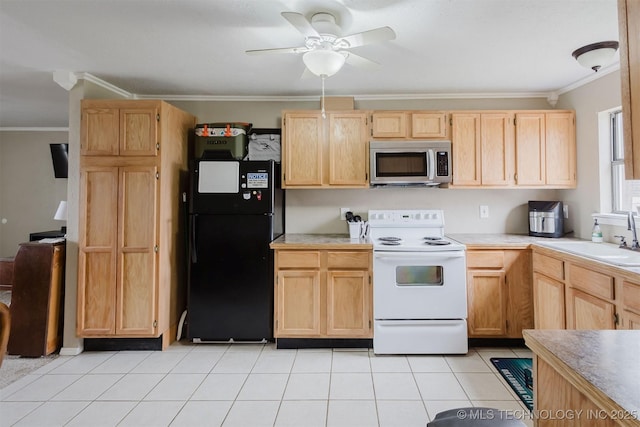 kitchen with light brown cabinets, a sink, electric stove, freestanding refrigerator, and stainless steel microwave