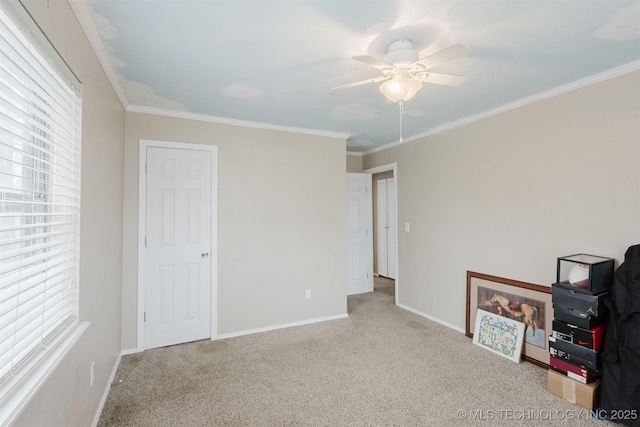 carpeted bedroom with baseboards, ornamental molding, and ceiling fan