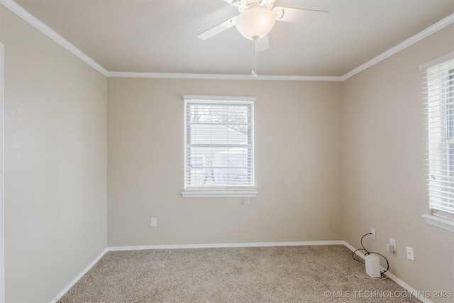 spare room featuring ornamental molding, carpet flooring, baseboards, and a ceiling fan