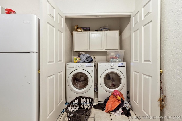 laundry room with tile patterned flooring, cabinet space, and independent washer and dryer