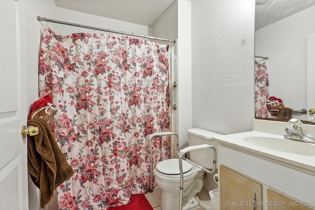 full bathroom with toilet, a stall shower, a textured wall, and vanity