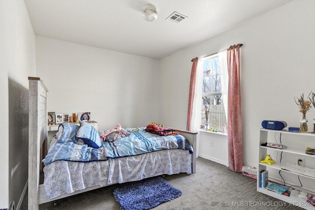 carpeted bedroom with visible vents and baseboards