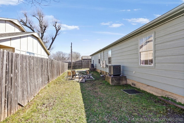 view of yard featuring fence and central air condition unit