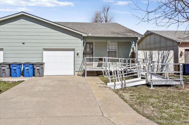 ranch-style house with a porch, concrete driveway, roof with shingles, and a garage