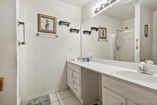 full bath with a stall shower, visible vents, a sink, and tile patterned floors