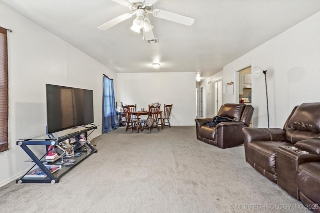 carpeted living area with visible vents and a ceiling fan