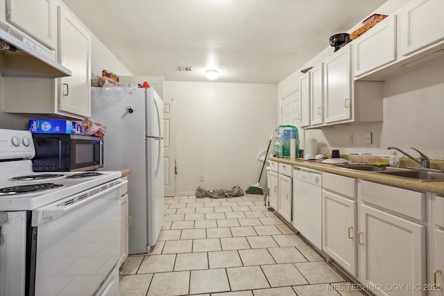 kitchen with under cabinet range hood, white appliances, a sink, visible vents, and white cabinets