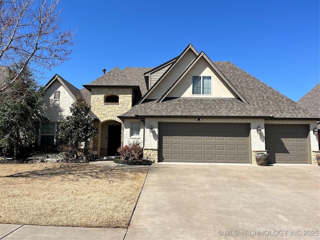 french country home featuring a garage, stone siding, roof with shingles, and concrete driveway