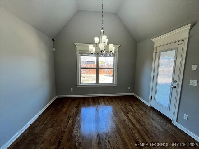 unfurnished dining area with dark wood-style flooring, vaulted ceiling, and baseboards