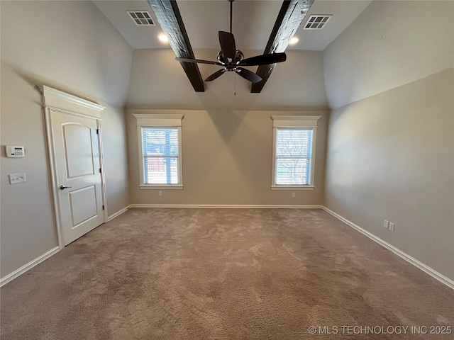 empty room featuring plenty of natural light, a high ceiling, and visible vents