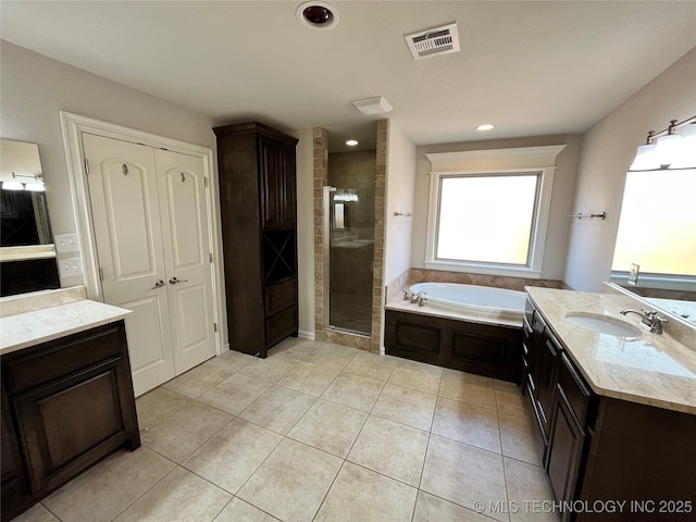 bathroom with visible vents, a stall shower, vanity, a bath, and tile patterned floors