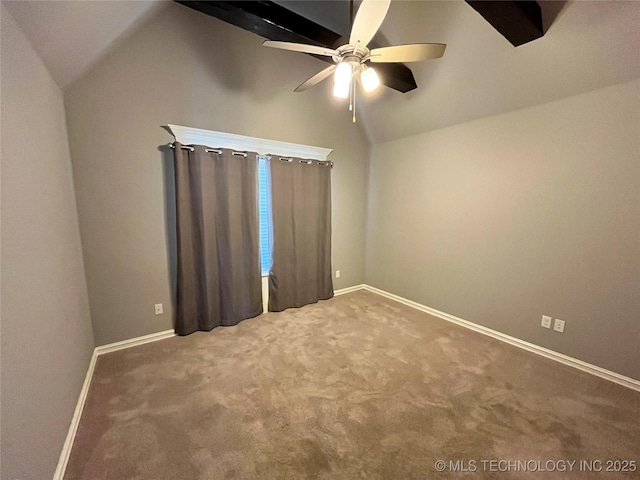 carpeted empty room featuring lofted ceiling, baseboards, and a ceiling fan