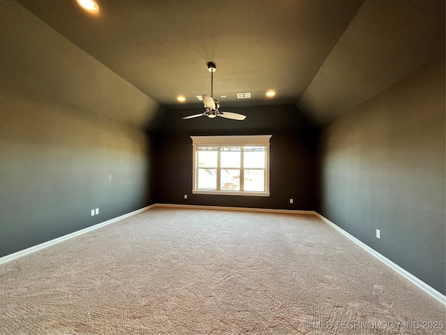 carpeted empty room with visible vents, baseboards, a ceiling fan, vaulted ceiling, and recessed lighting