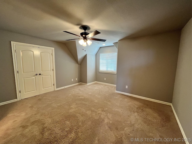 bonus room with ceiling fan, carpet flooring, and baseboards