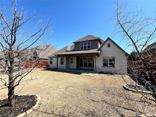 back of house with a patio area, a fenced backyard, and roof with shingles