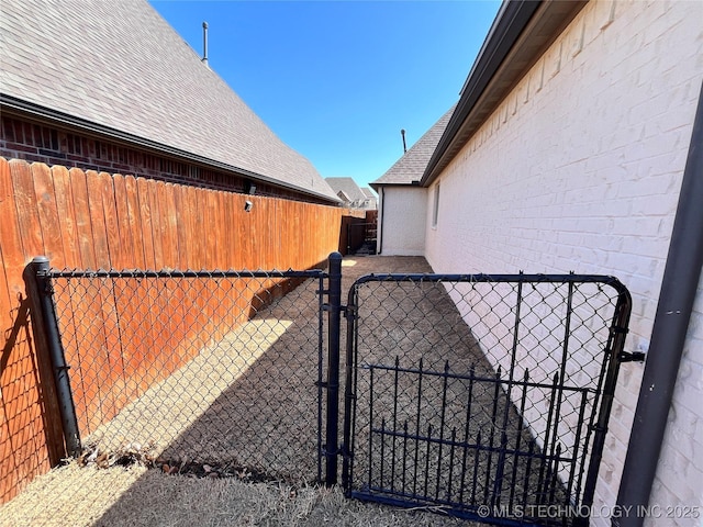 view of gate featuring fence