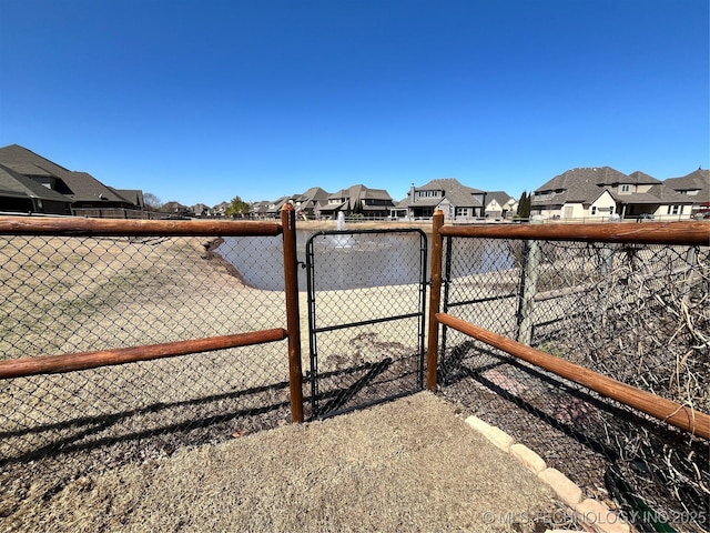 view of yard with a gate, a residential view, and fence