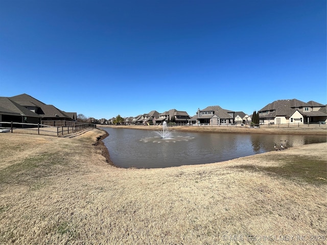 view of water feature with fence and a residential view