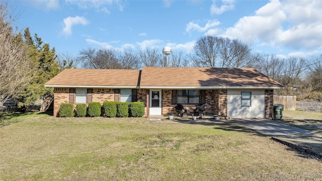 ranch-style house with a front yard and brick siding