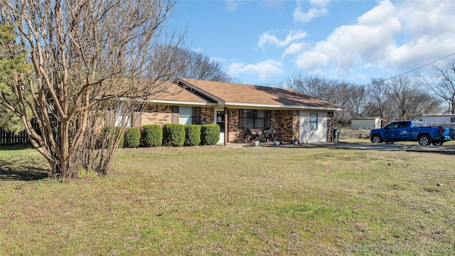 ranch-style home featuring brick siding and a front lawn