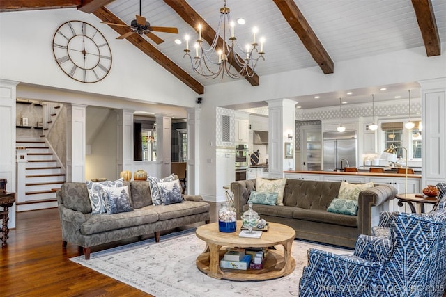 49721 E 95th Rd, Miami, OK 74354 - living room featuring beam ceiling, high vaulted ceiling, wood finished floors, ceiling fan, and ornate columns