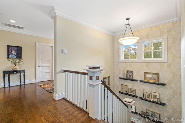 49721 E 95th Rd, Miami, OK 74354 - hallway featuring dark wood-style floors, baseboards, visible vents, ornamental molding, and an upstairs landing