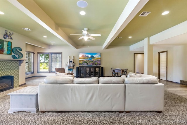 49721 E 95th Rd, Miami, OK 74354 - living room with a ceiling fan, visible vents, recessed lighting, a tile fireplace, and beamed ceiling