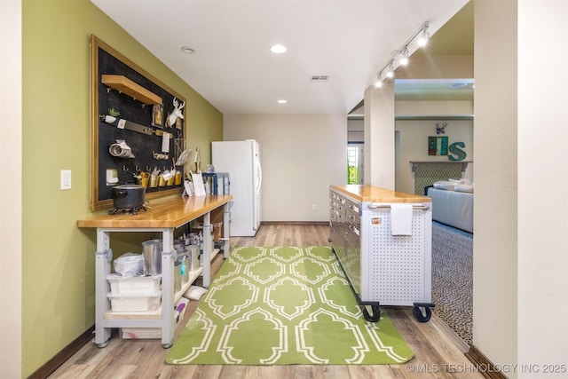 49721 E 95th Rd, Miami, OK 74354 - kitchen featuring visible vents, freestanding refrigerator, baseboards, and wood finished floors