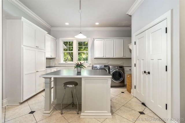 49721 E 95th Rd, Miami, OK 74354 - laundry room featuring crown molding, light tile patterned floors, cabinet space, and washing machine and clothes dryer