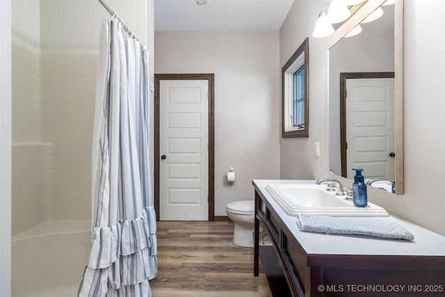 49721 E 95th Rd, Miami, OK 74354 - full bath featuring curtained shower, toilet, wood finished floors, and vanity