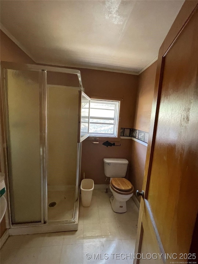 full bathroom featuring toilet and a shower stall