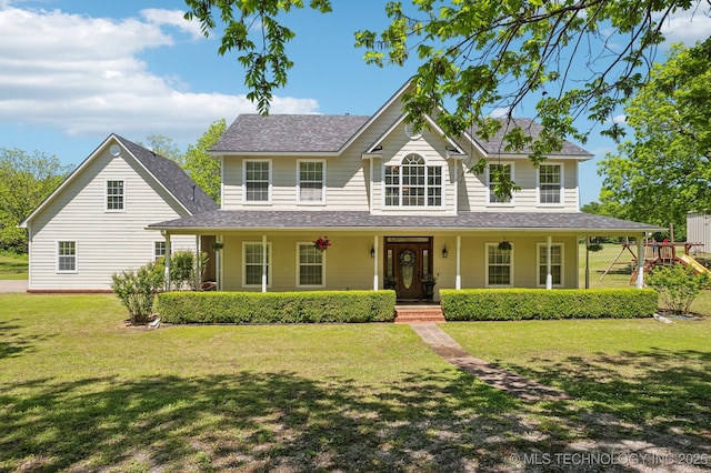 view of front of house featuring a porch, a playground, and a front lawn