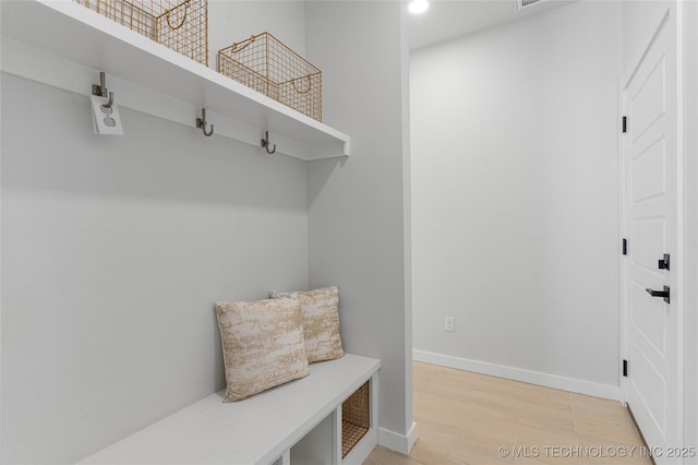 mudroom featuring light wood-style floors and baseboards