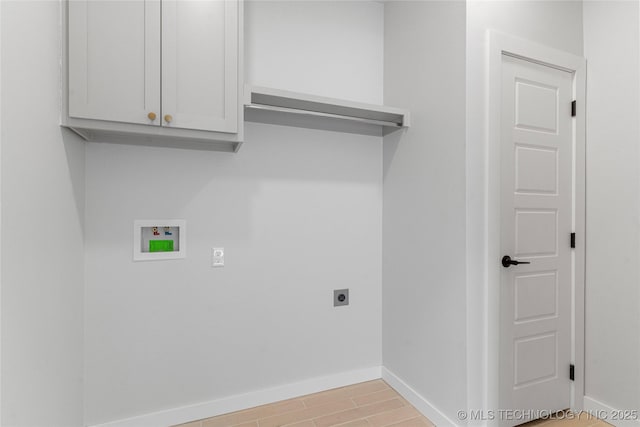 washroom with light wood-style flooring, hookup for an electric dryer, washer hookup, baseboards, and cabinet space