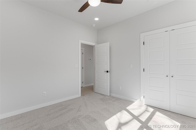 unfurnished bedroom with ceiling fan, recessed lighting, light colored carpet, baseboards, and a closet