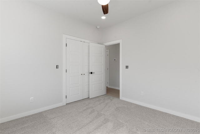 unfurnished bedroom featuring recessed lighting, a closet, carpet flooring, and baseboards