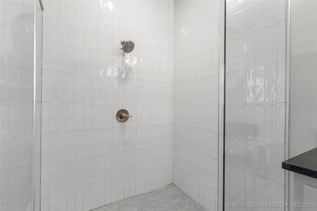 bathroom with tiled shower