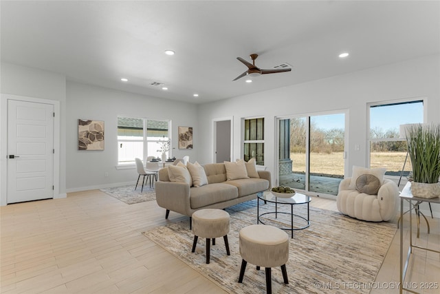 living area with baseboards, visible vents, a ceiling fan, and recessed lighting