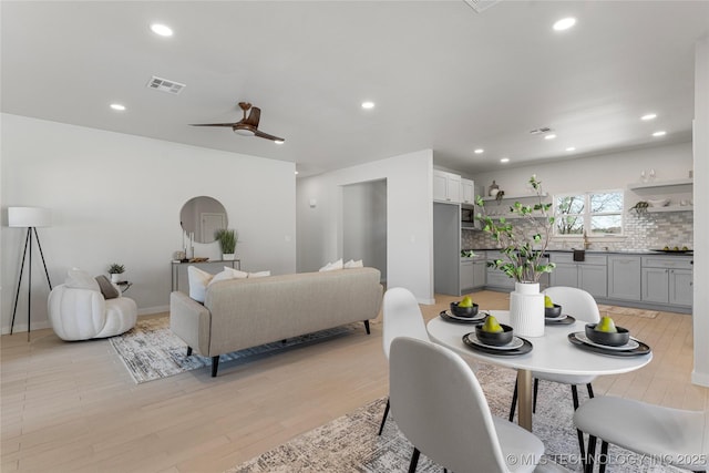 dining area with recessed lighting, a ceiling fan, baseboards, visible vents, and light wood-style floors