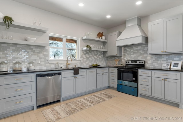 kitchen featuring electric range, open shelves, stainless steel dishwasher, and custom exhaust hood