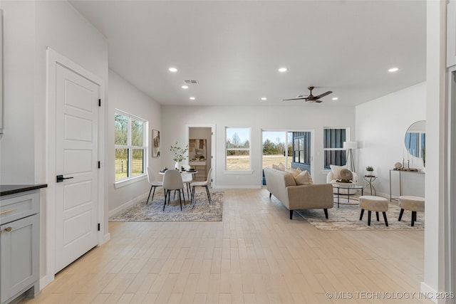 living room featuring light wood-style floors, recessed lighting, and visible vents